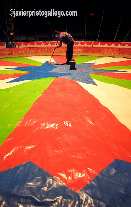 Un mozo limpia la pista del Circo Mundial.